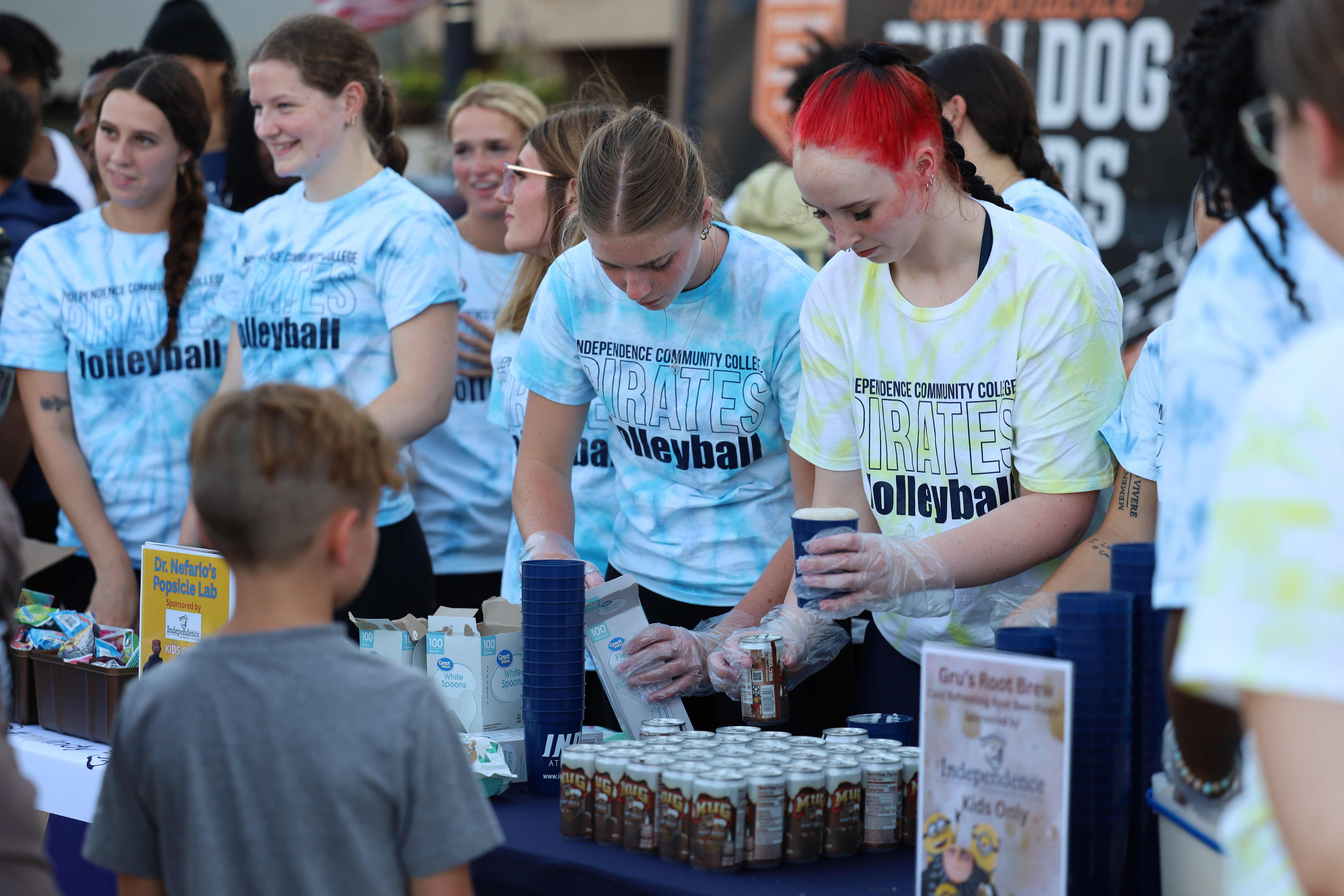 students giving out cups